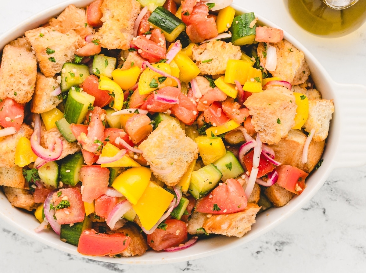Panzanella, or Italian bread salad, is a Tuscan favorite that's hard to resist. It's all about that perfect combo of crusty, day-old bread soaking up the juices from the ripest, juiciest tomatoes—once you start, it's impossible to stop. panzanella salad