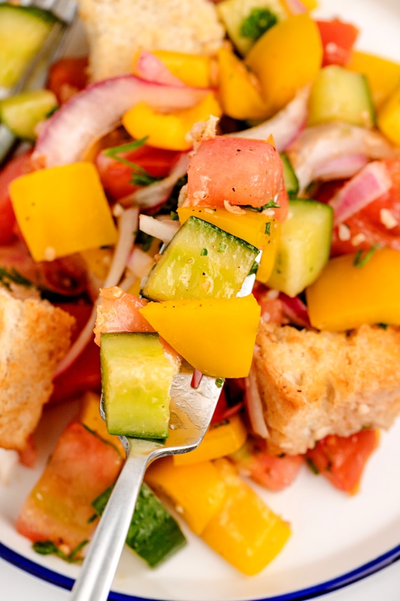 Panzanella, or Italian bread salad, is a Tuscan favorite that's hard to resist. It's all about that perfect combo of crusty, day-old bread soaking up the juices from the ripest, juiciest tomatoes—once you start, it's impossible to stop. recipe Tuscan bread salad
