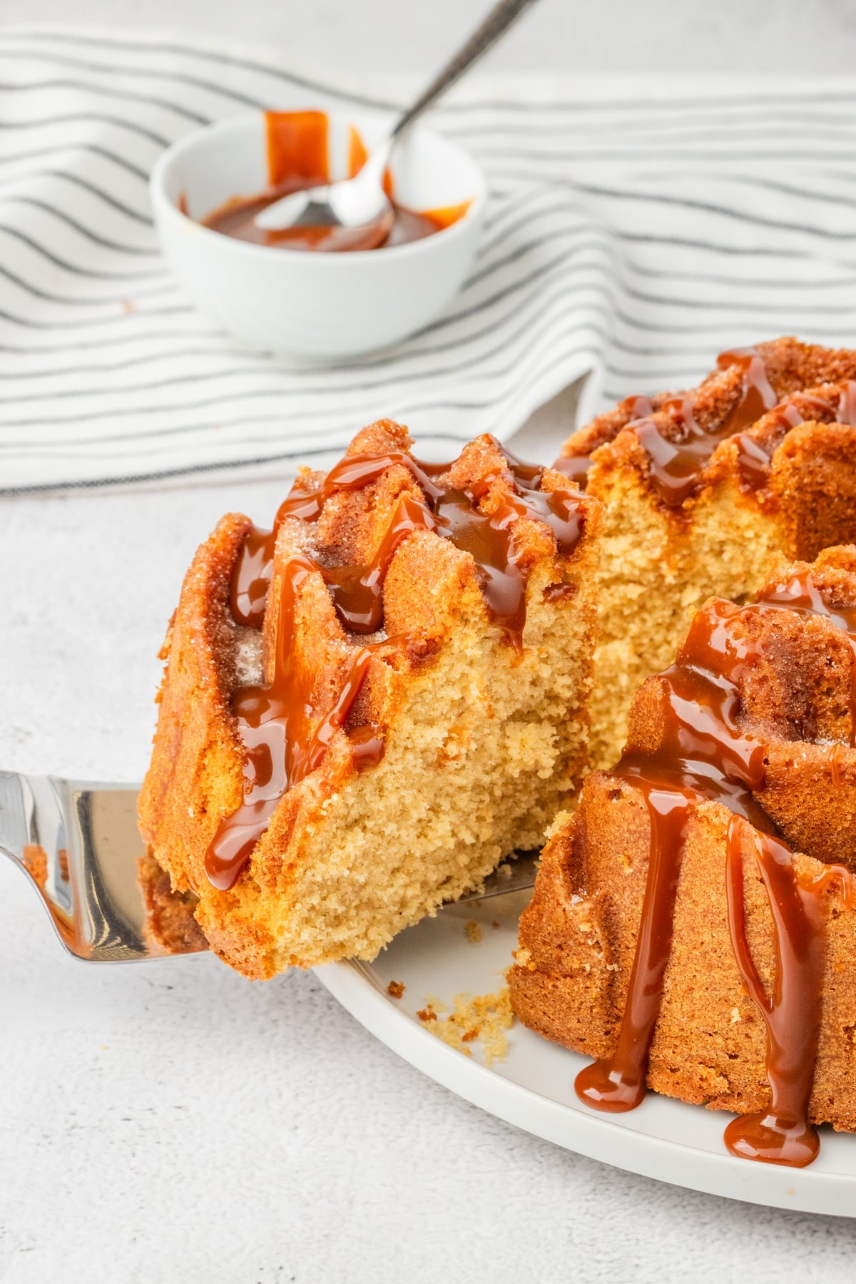 a slice of churro cake being removed
