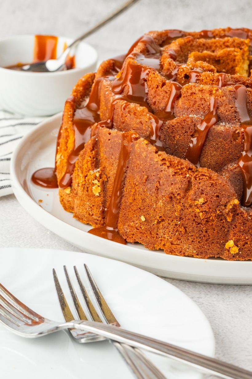 churro cake side view with dulce de leche dripping