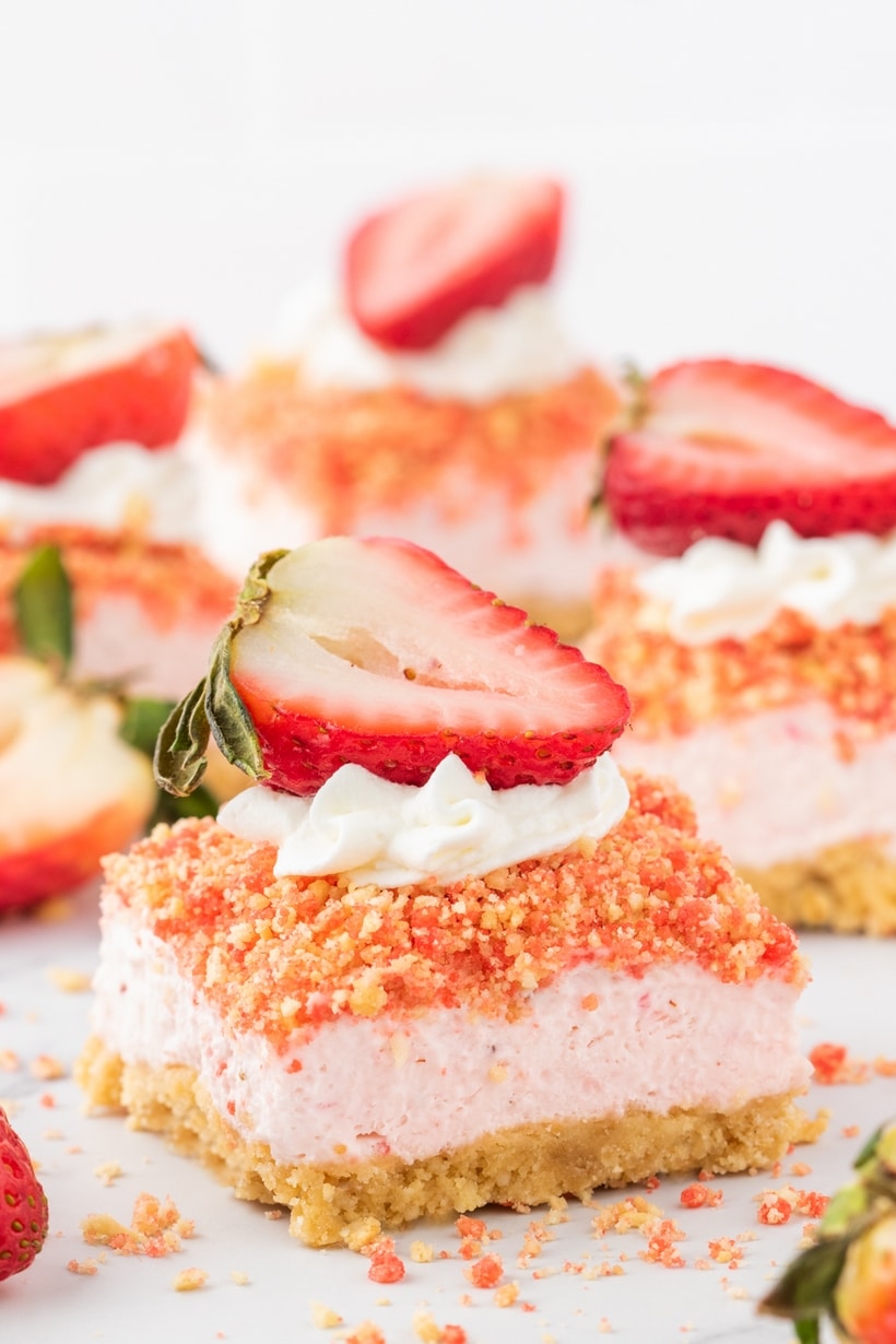 Rich and creamy cheesecake bars kissed with fresh strawberries and studded with a crumbly strawberry crunch are the official answer to what to serve to your favorite people in the coming weeks. With a quick press-in golden Oreo crust, a simple cream cheese base, and a short trip to the oven, they couldn’t be easier to make. These bars are a treat fit for a celebration. oreo strawberry cheesecake