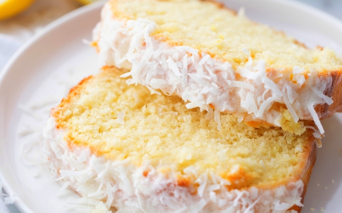 Close-up of two slices of lemon loaf, highlighting the crumb and glaze.