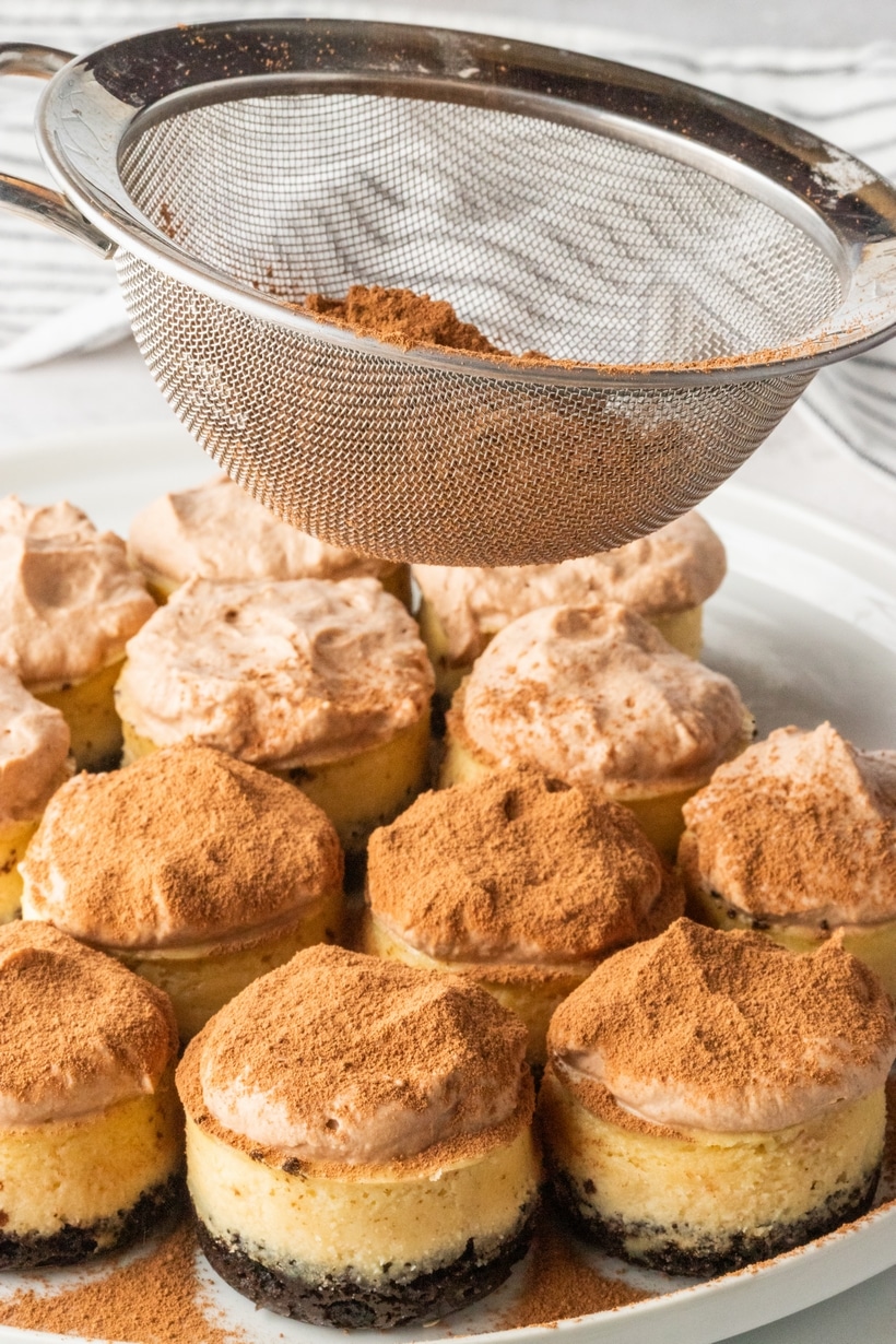 These irresistible mini-sized espresso cheesecakes are nestled on a Oreo cookie base and crowned with a luscious cloud of chocolate whipped topping that is generously dusted with cocoa powder. These mini cheesecakes are an indulgence fit for any occasion, with a special nod to the holiday season. mini espresso cheesecakes