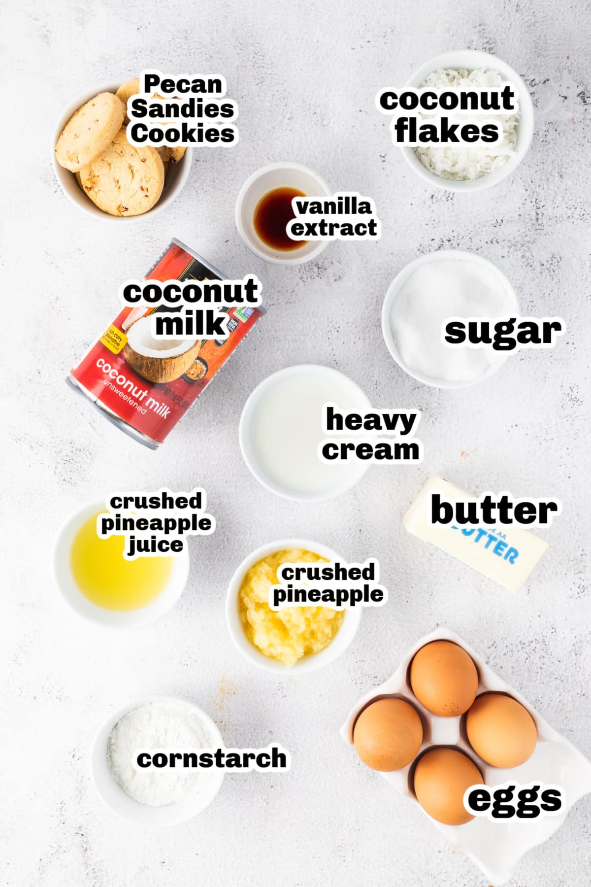 Overhead shot of measured ingredients for pineapple coconut cream pie arranged on a counter.