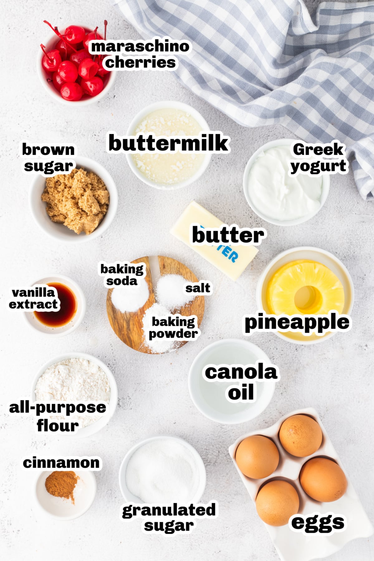Ingredients for Pineapple Upside Down Cake with Greek Yogurt Labeled ingredients for pineapple upside down Bundt cake including pineapple rings, brown sugar, Greek yogurt, and eggs.