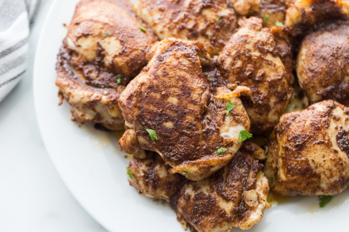 Top view of Air Fryer Caribbean Spiced Chicken arranged on a platter, showcasing its rich color and seasoning.