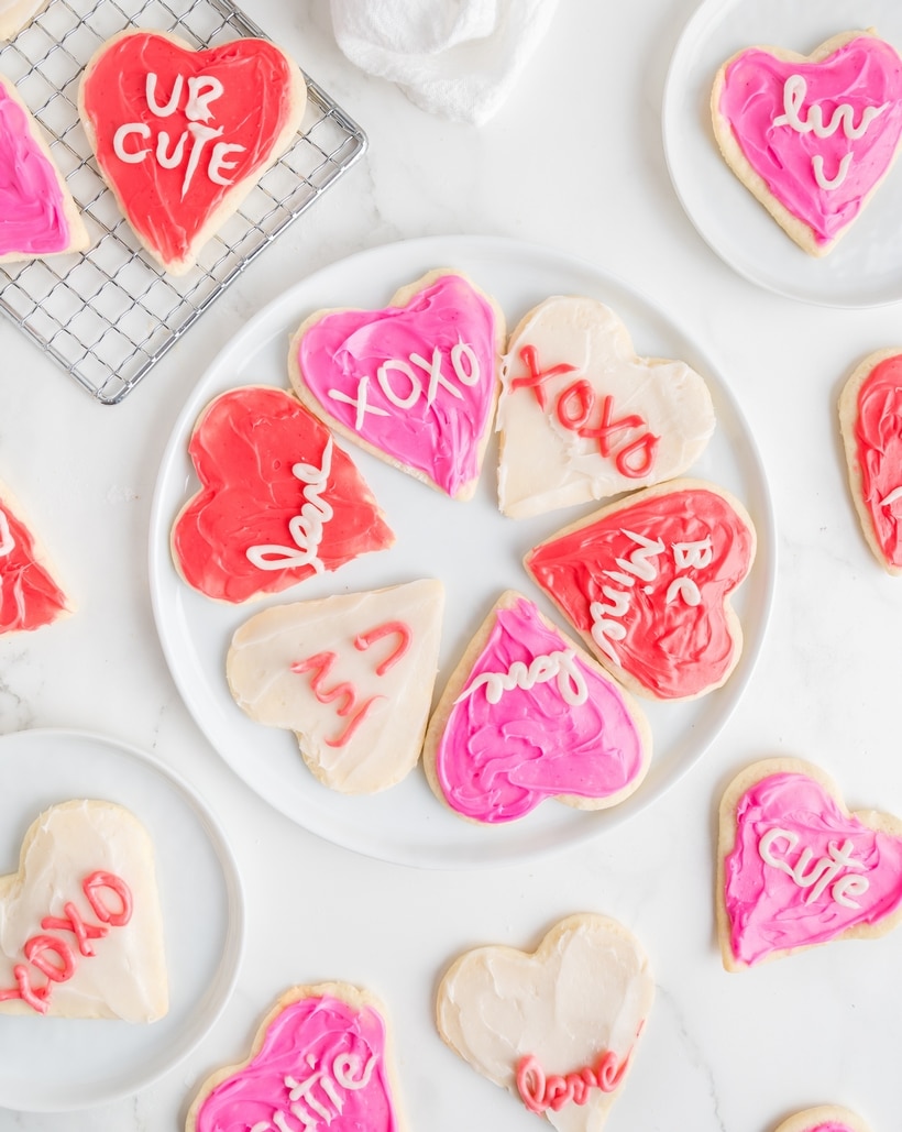 Heart-Shaped Sugar Cookies on a plate. Heart-shaped sugar cookies frosted with pink and red icing.