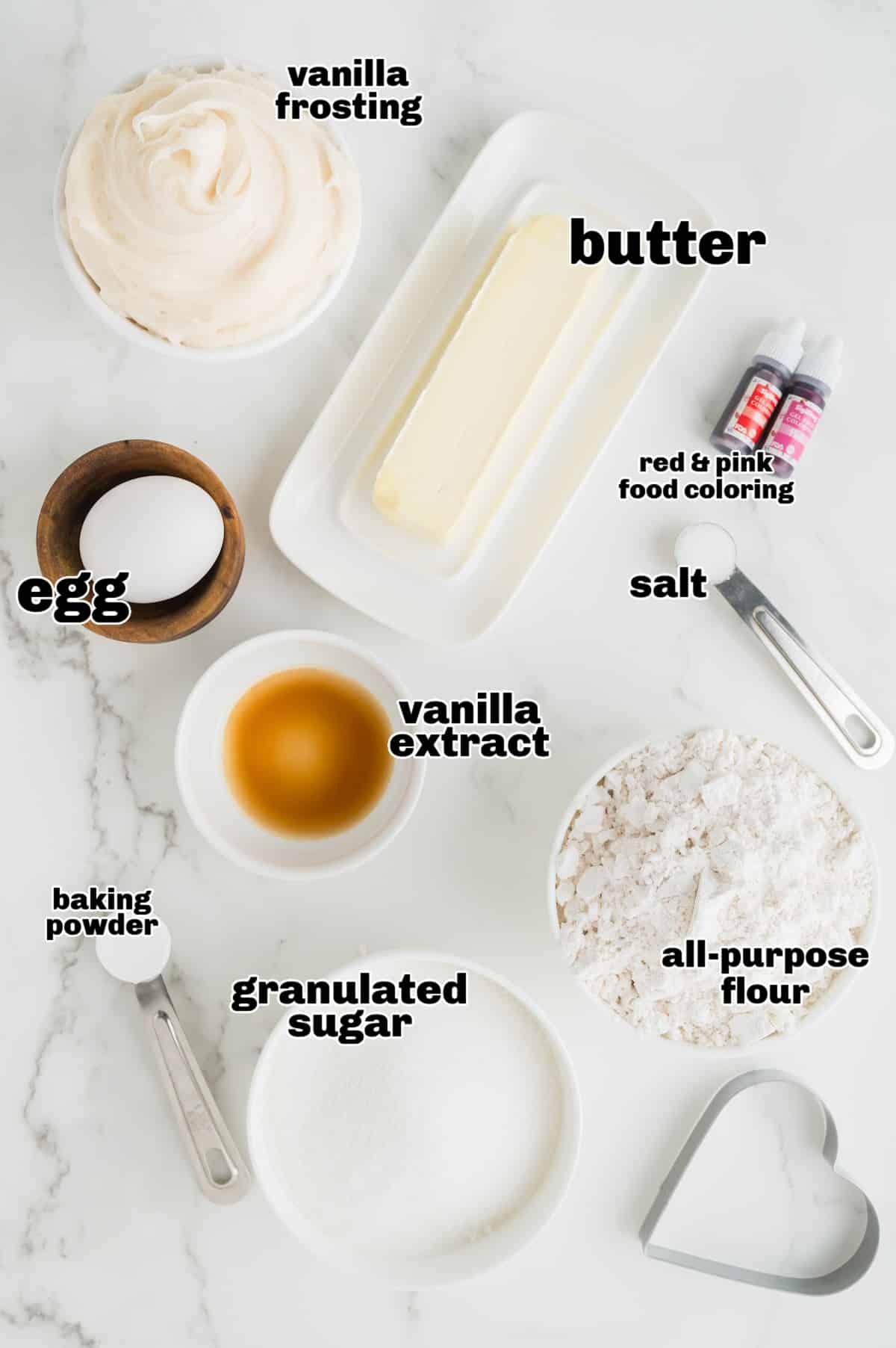 Heart-Shaped Sugar Cookies A flat lay of ingredients including butter, sugar, flour, and food coloring, arranged for making the cookies.