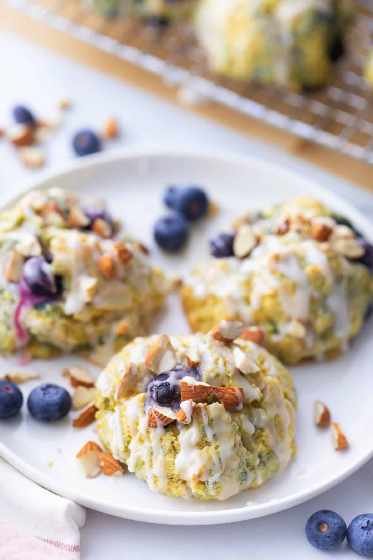Cornmeal-Blueberry Drop Scones on a plate A plate of golden-brown cornmeal-blueberry drop scones, showcasing their crisp edges and soft texture.