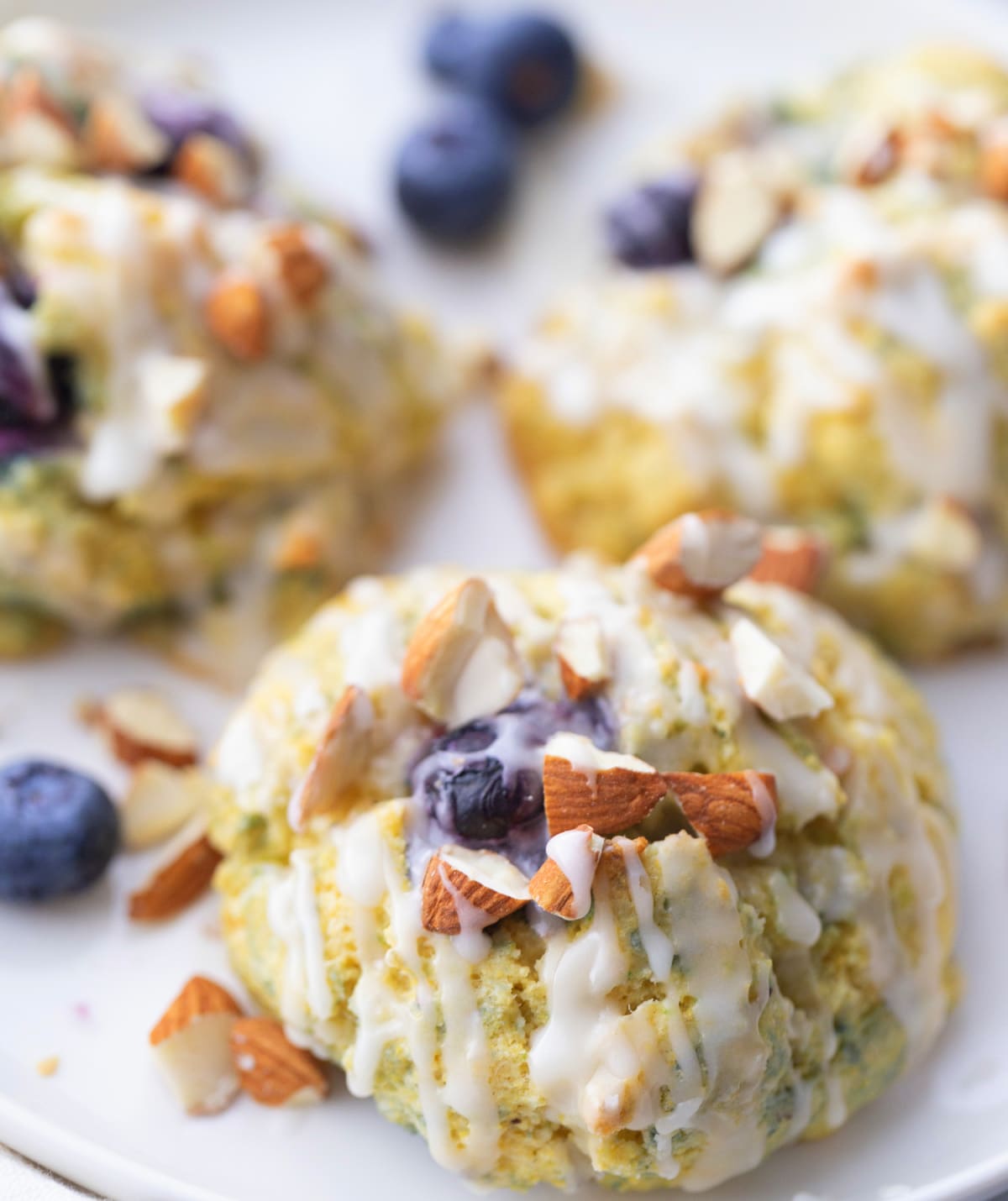 Cornmeal-Blueberry Drop Scones ready to eat A fresh batch of cornmeal-blueberry scones piled on a plate, with blueberries visible throughout.
