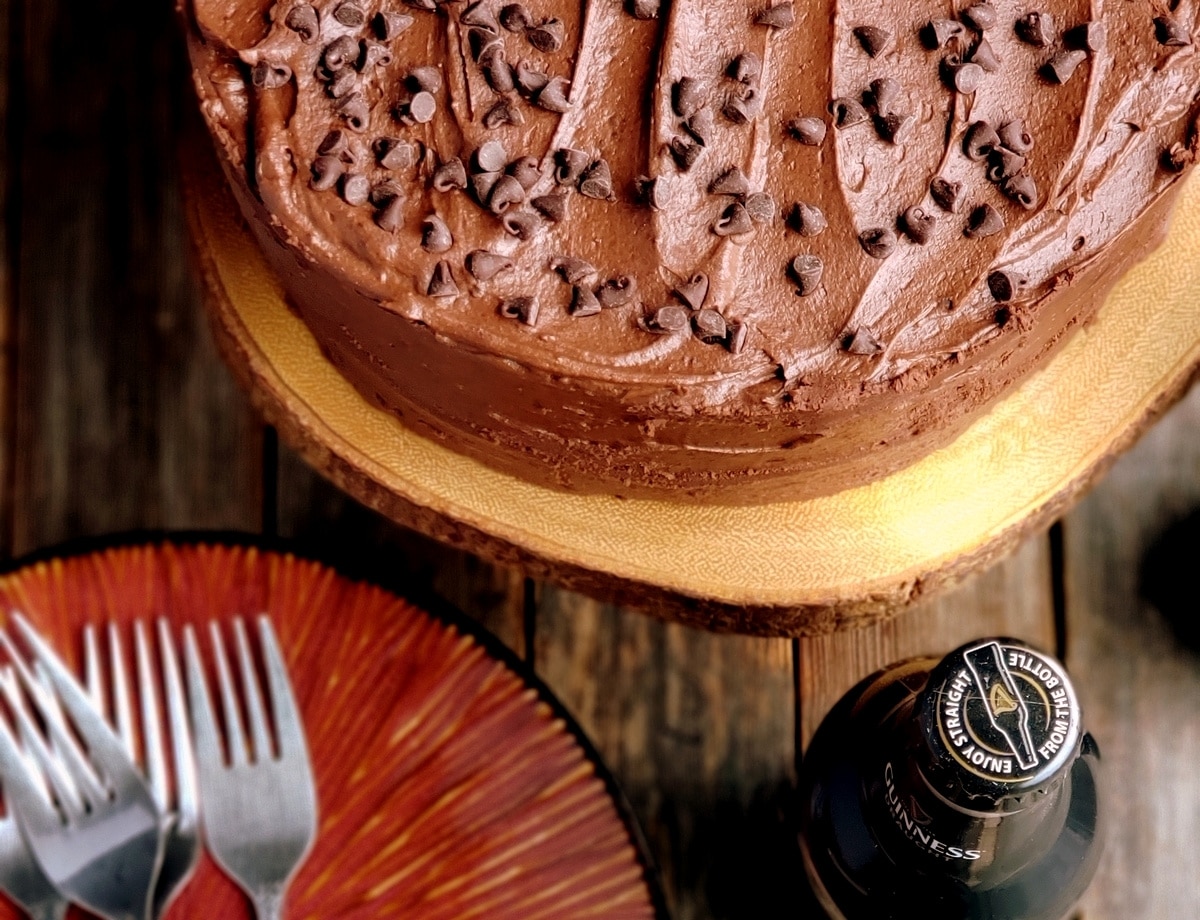 close-up of Guinness chocolate layer cake with chocolate icing and mini chocolate chips