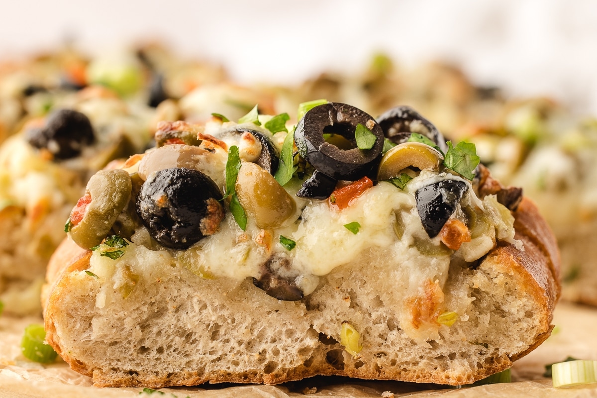 Indulge in this irresistible olive cheese bread recipe. Perfect as a party appetizer or a side dish for your favorite main course. bread with olives and cheese