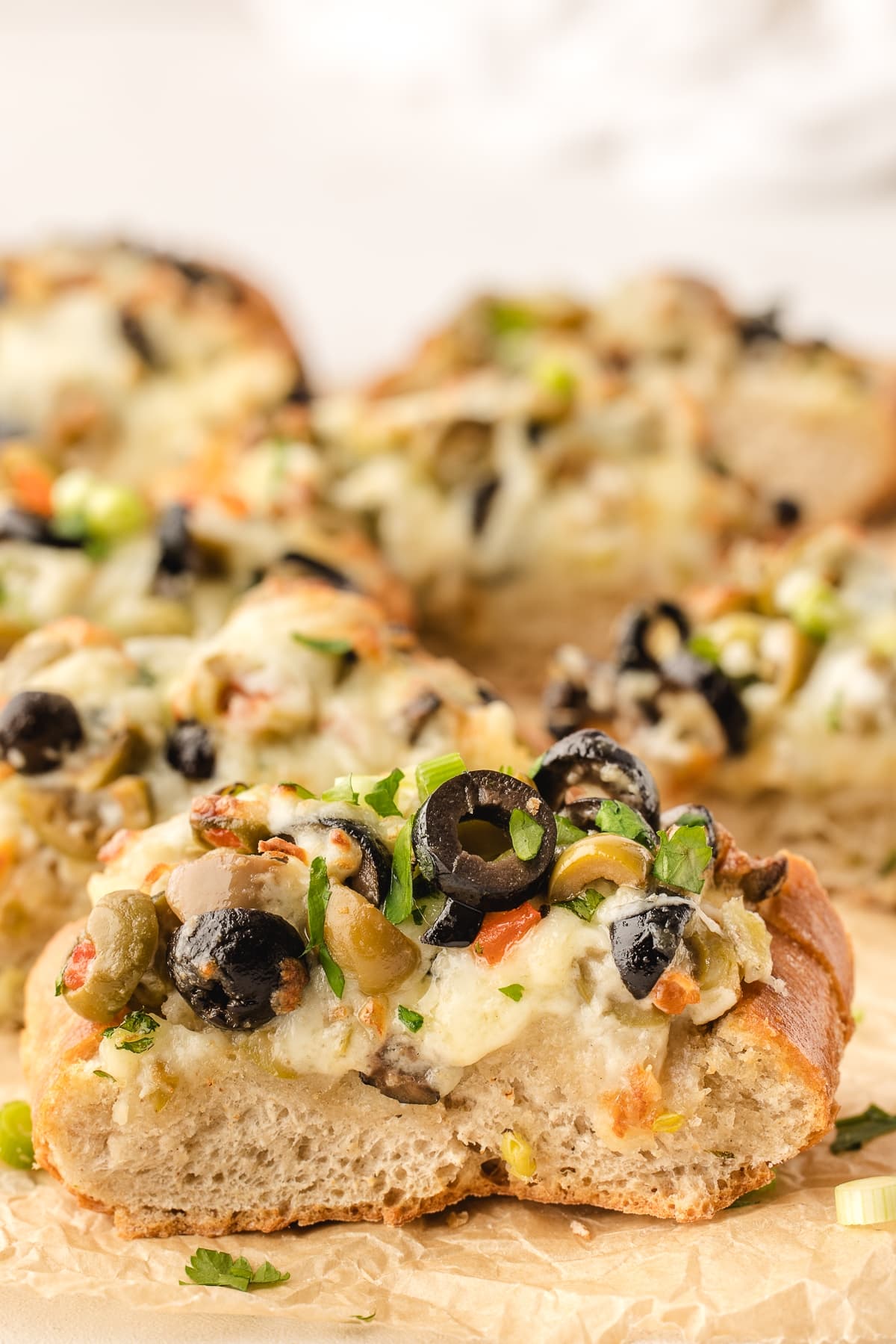 Indulge in this irresistible olive cheese bread recipe. Perfect as a party appetizer or a side dish for your favorite main course. cheesy bread with olives