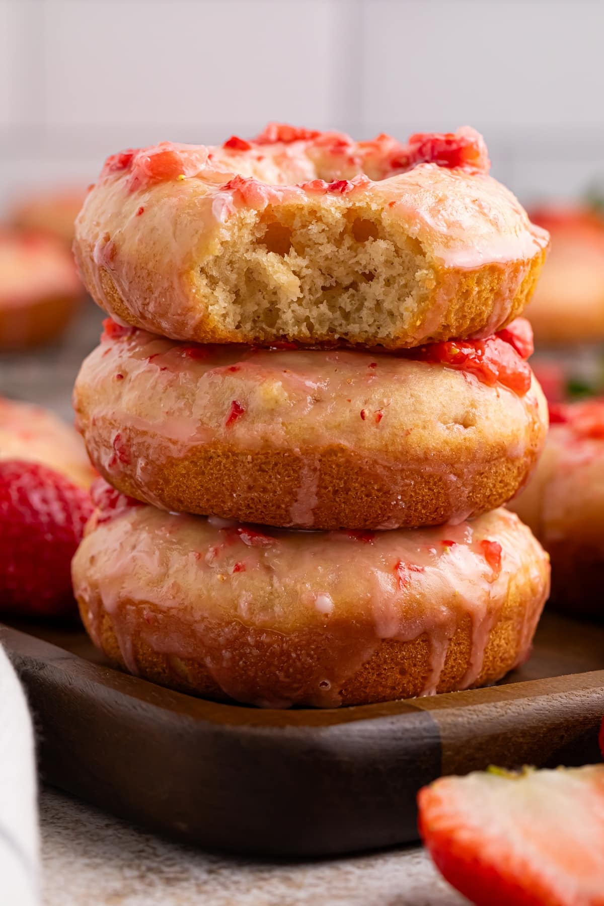 This is the perfect recipe for strawberry glazed baked doughnuts. What could better than fluffy vanilla doughnuts topped with a sweet and tangy, fresh strawberry glaze. These doughnuts are perfect for a weekend breakfast, back-to-school treat, brunch or a holiday morning. baked strawberry doughnuts