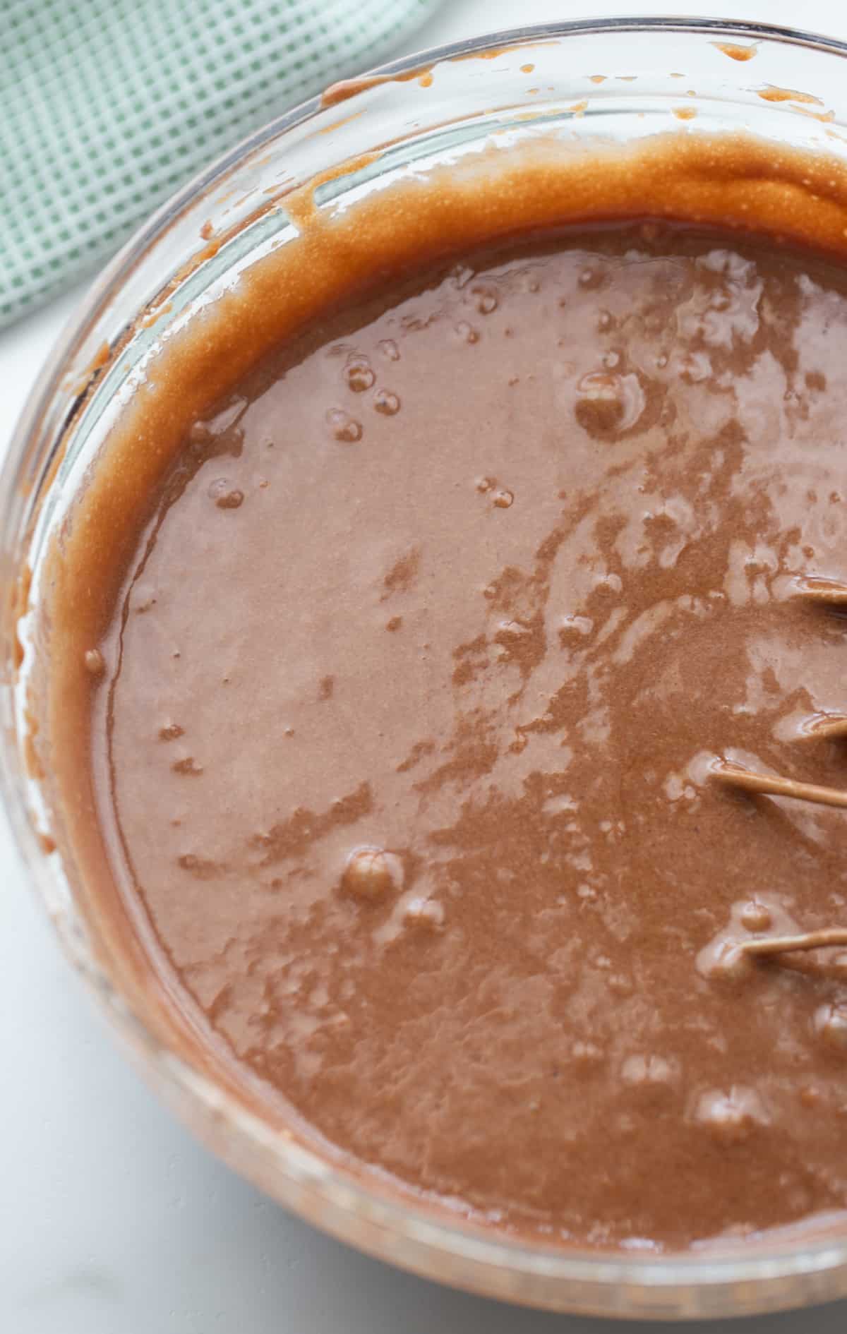 Thick, glossy brownie batter with peppermint and bourbon mixed in