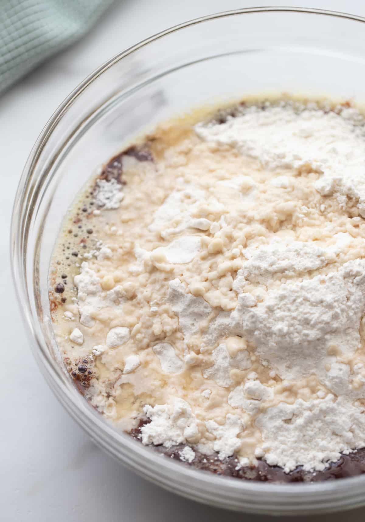 Flour, sugar, and salt combined in a clear mixing bowl, ready for brownie batter