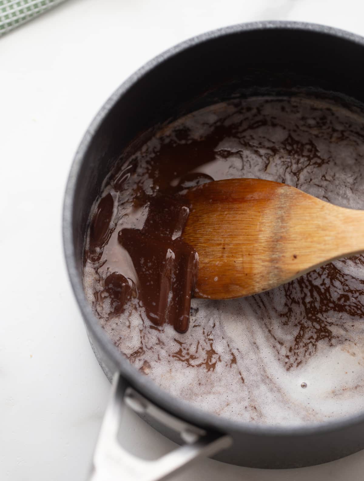 Butter and dark chocolate melting together in a saucepan for the brownie base