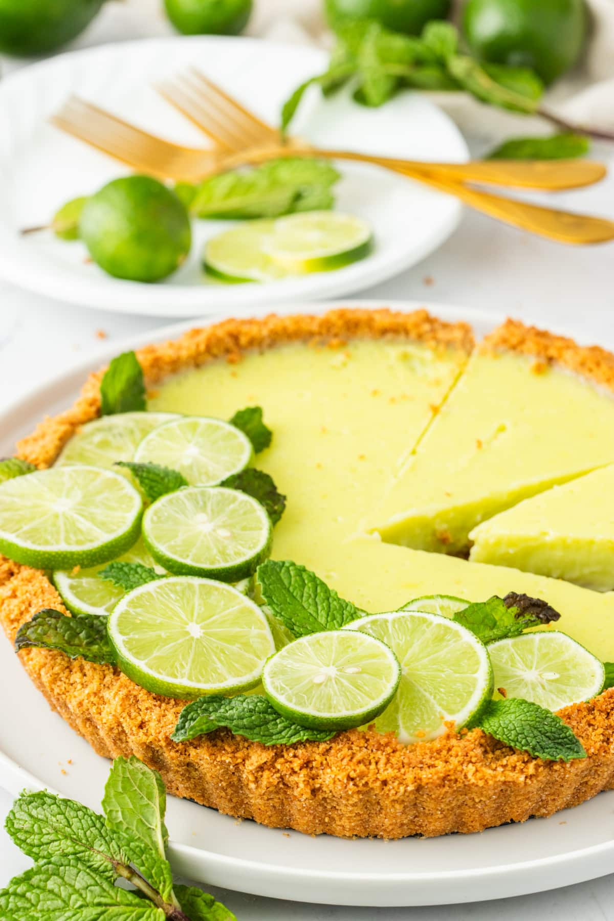 Whole Key lime tart with two slices slightly pulled out and ready to serve