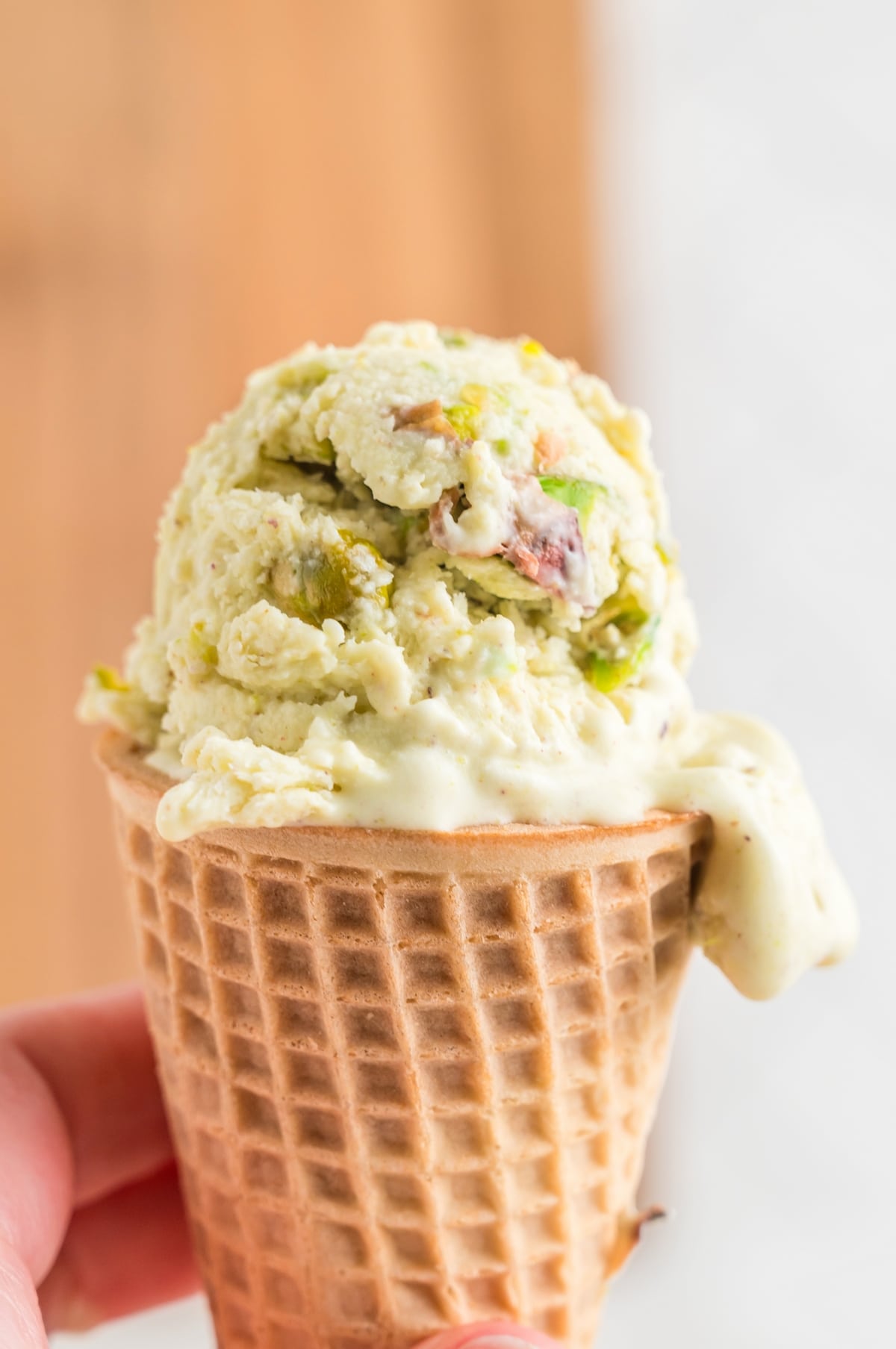 Make your own pistachio ice cream at home with this easy recipe. Enjoy the cool and creamy goodness of this nutty dessert. waffle cone with pistachio ice cream