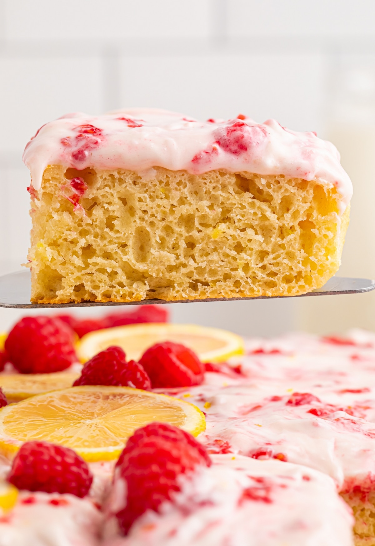 A buttermilk lemon raspberry frosted sheet cake made with —sun-ripened raspberries and tart lemon. It's one deliciously tender cake! frosted raspberry sheet cake