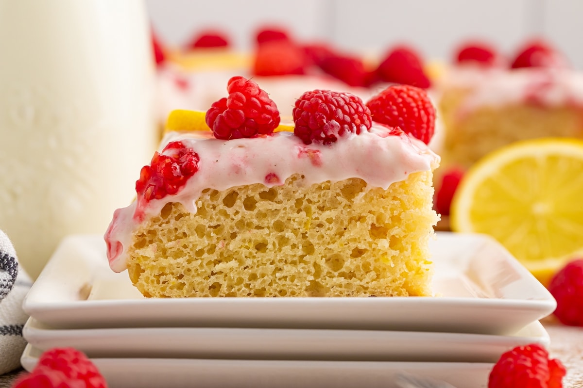 A buttermilk lemon raspberry frosted sheet cake made with —sun-ripened raspberries and tart lemon. It's one deliciously tender cake! lemon raspberry cake