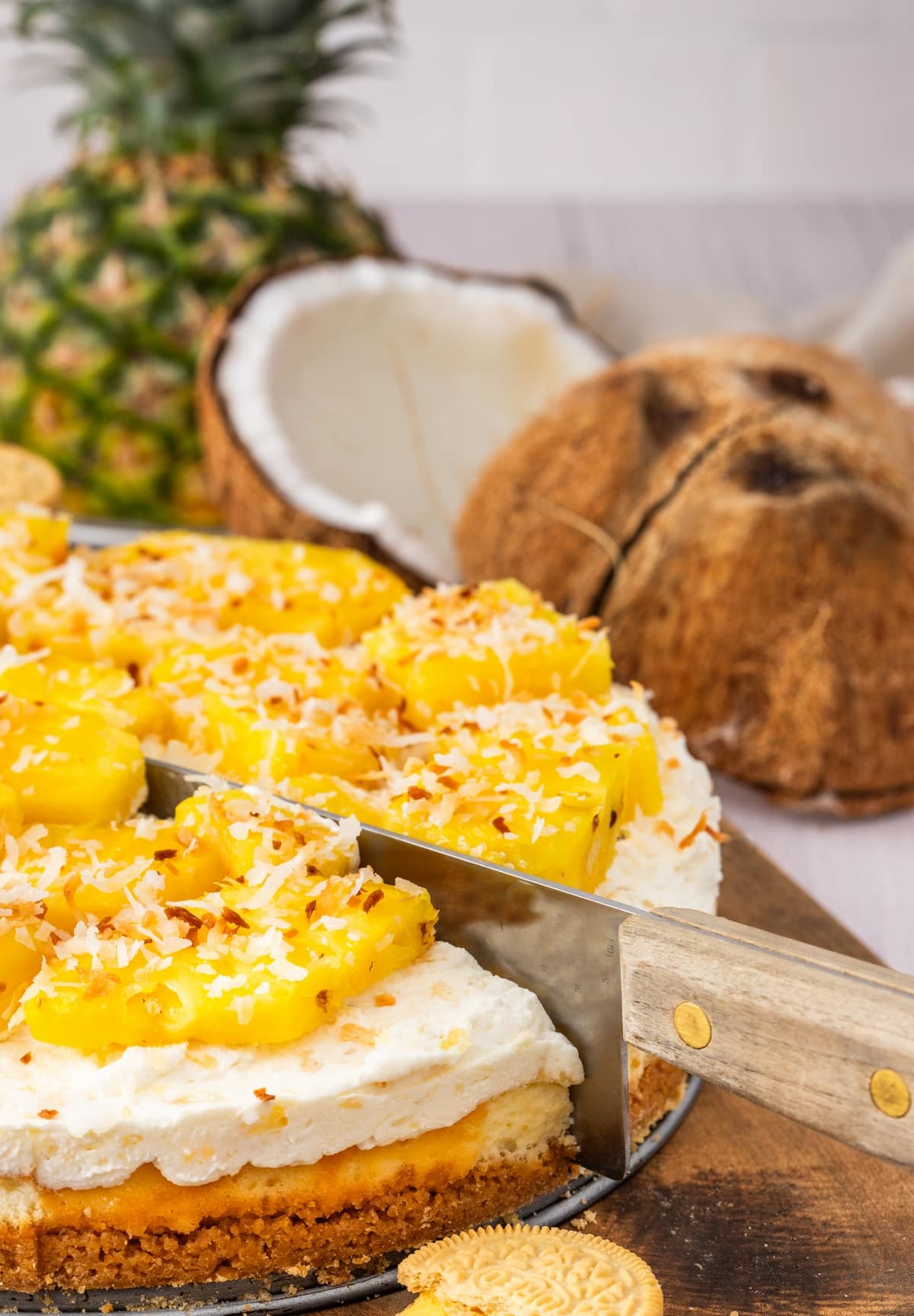 You'll love the tropical flavors of this pineapple delight cheesecake, featuring a golden Oreo crust, rich cream cheese layer, and fluffy pineapple mousse, topped with fresh pineapple and coconut. It's perfect for any gathering, from barbecues to potlucks. pineapple mousse