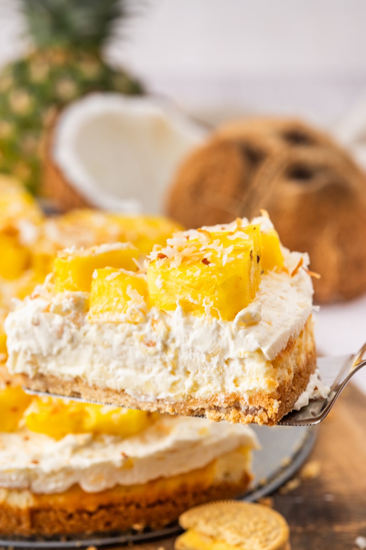 You'll love the tropical flavors of this pineapple delight cheesecake, featuring a golden Oreo crust, rich cream cheese layer, and fluffy pineapple mousse, topped with fresh pineapple and coconut. It's perfect for any gathering, from barbecues to potlucks. pineapple cheesecake