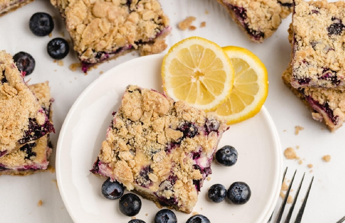 Overhead view of lemon blueberry crumble bars with lemon slices