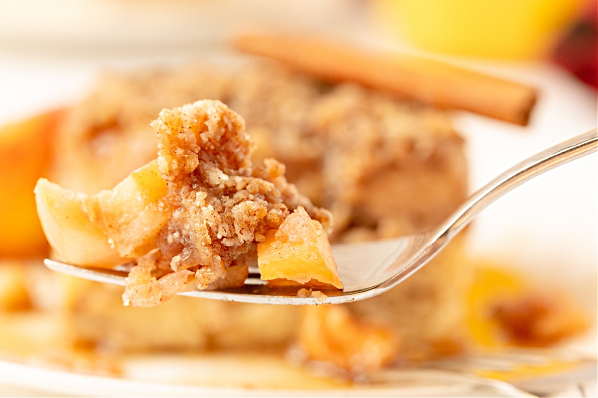 Cinnamon Apple French Toast Bake Bite Bite of cinnamon apple french toast bake on a fork.