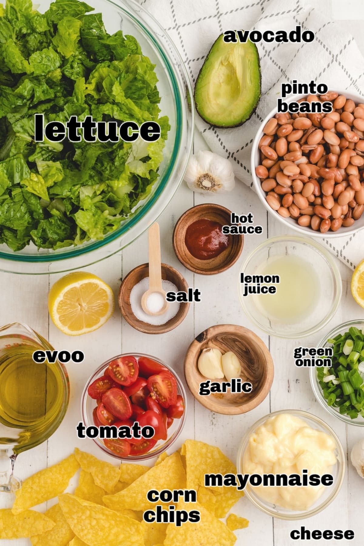 Avocado dressing and mexican salad ingredients on a board ready to blend Fresh ingredients for avocado dressing and mexican salad laid out on a board including avocado, mayo, lemon, and garlic