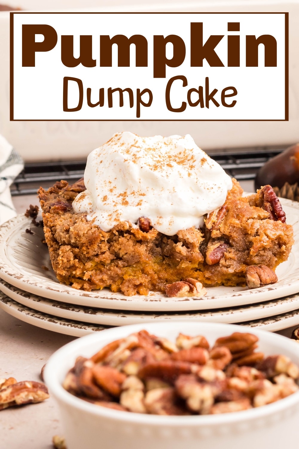 This pumpkin dump cake is the perfect blend of warm, spiced pumpkin and a buttery cake topping. A dollop of homemade whipped cream brings it all together. via @cmpollak1