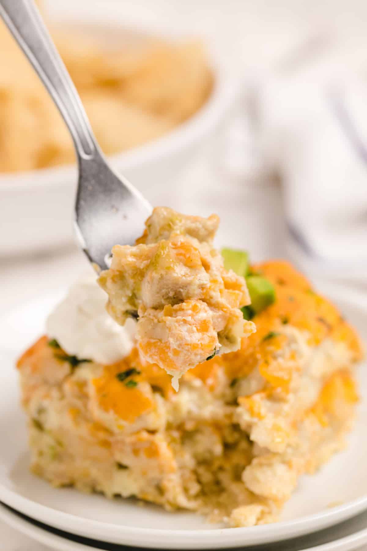 Bite of Green Chile Chicken Enchilada Casserole on fork Bite of Green Chile Chicken Enchilada Casserole on a fork