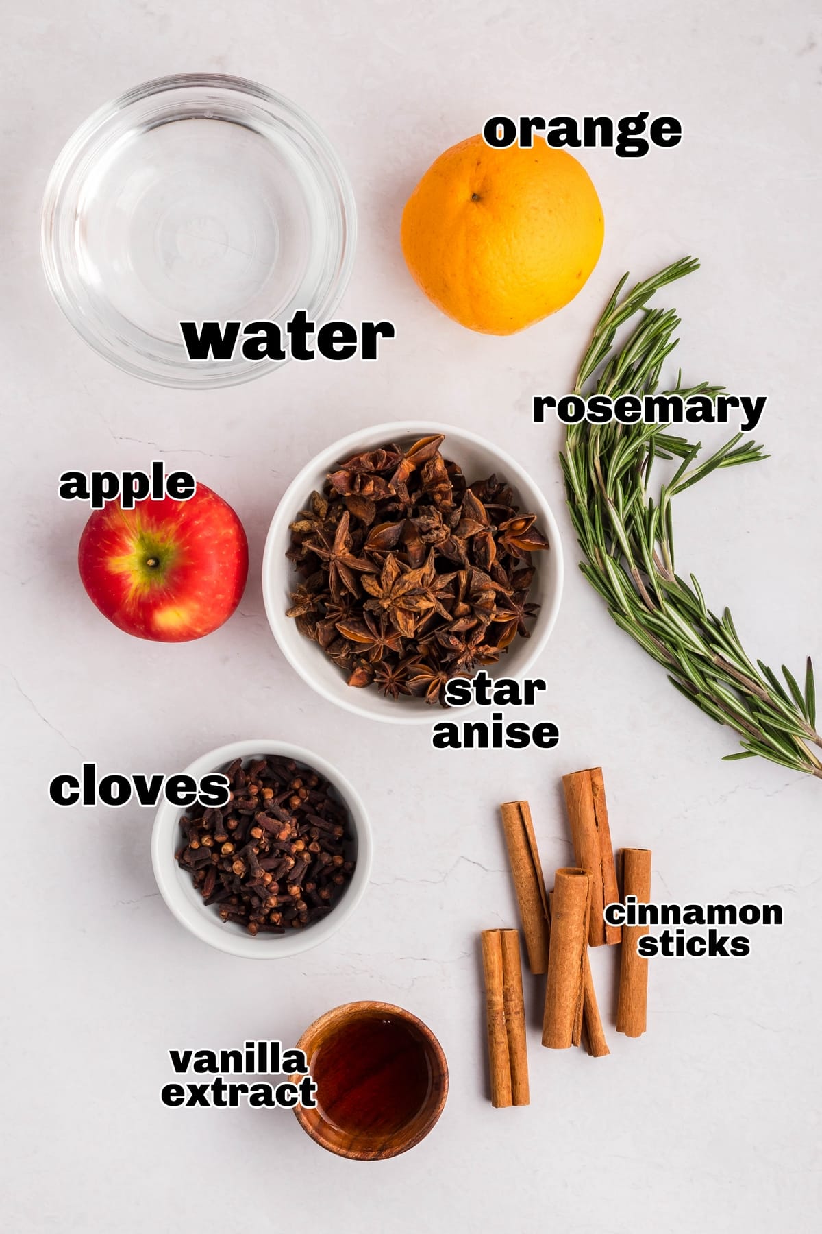 A selection of spices, citrus, and fruit ready for a holiday simmer pot.