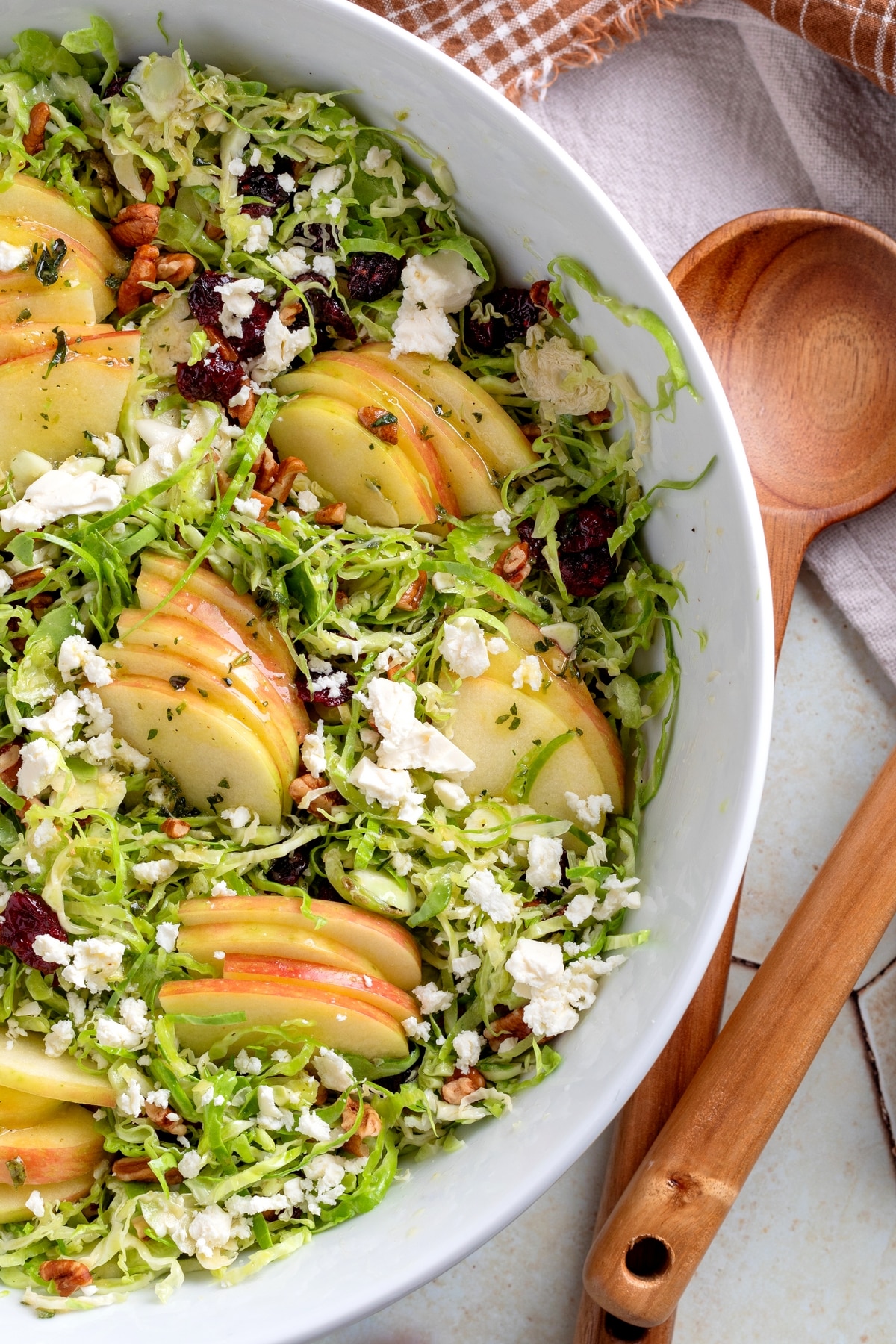Shaved Brussels Sprouts Salad ready to serve Shaved Brussels Sprouts Salad in a white bowl