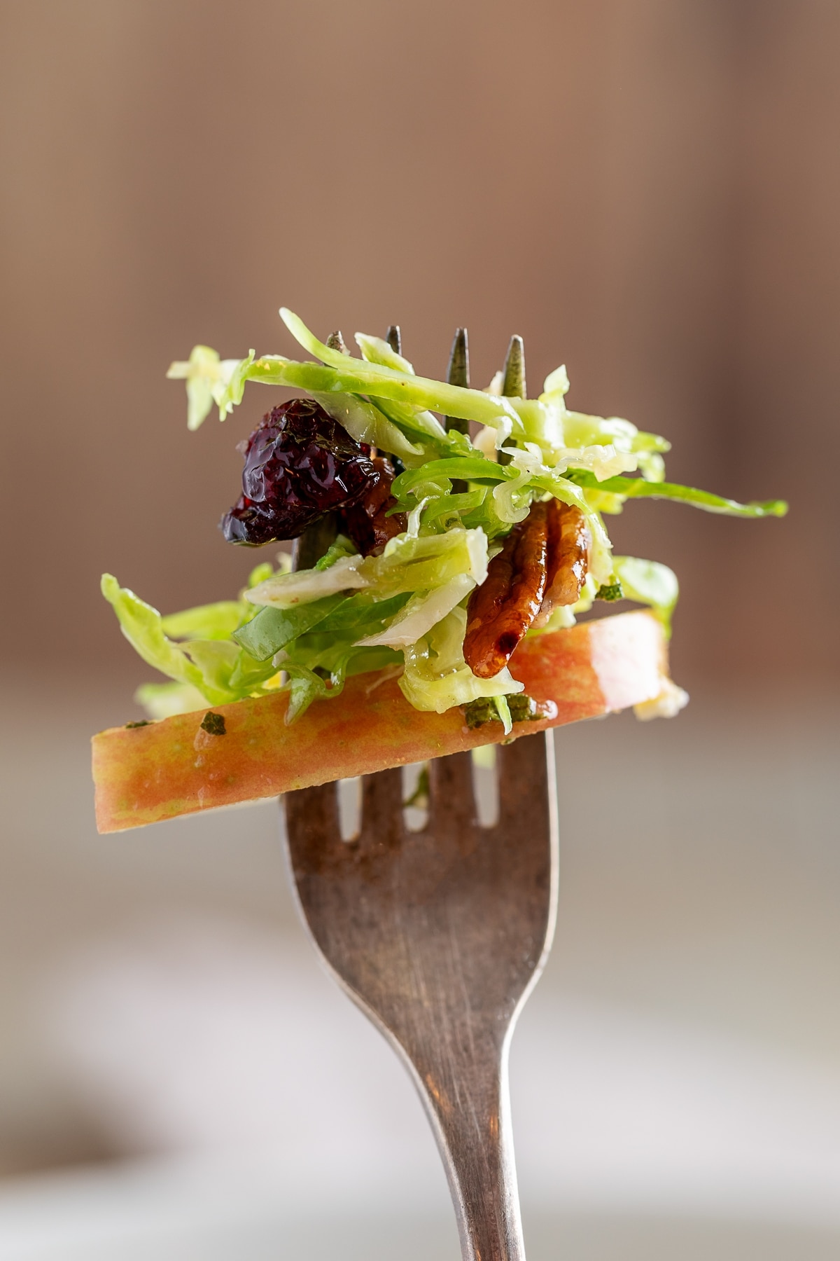 Brussels Sprouts Salad on a fork. A forkful of salad with mostly Brussels sprouts.