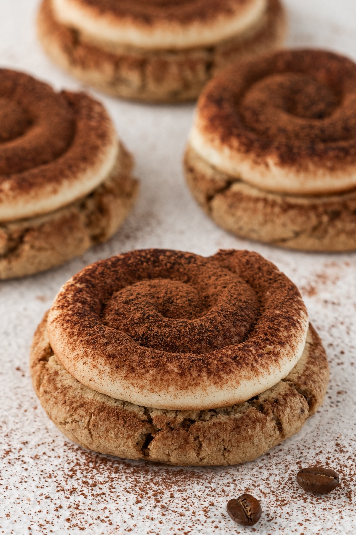 Plate of tiramisu cookies ready to serve. A plate of tiramisu cookies topped with mascarpone frosting and lightly dusted with cocoa powder.