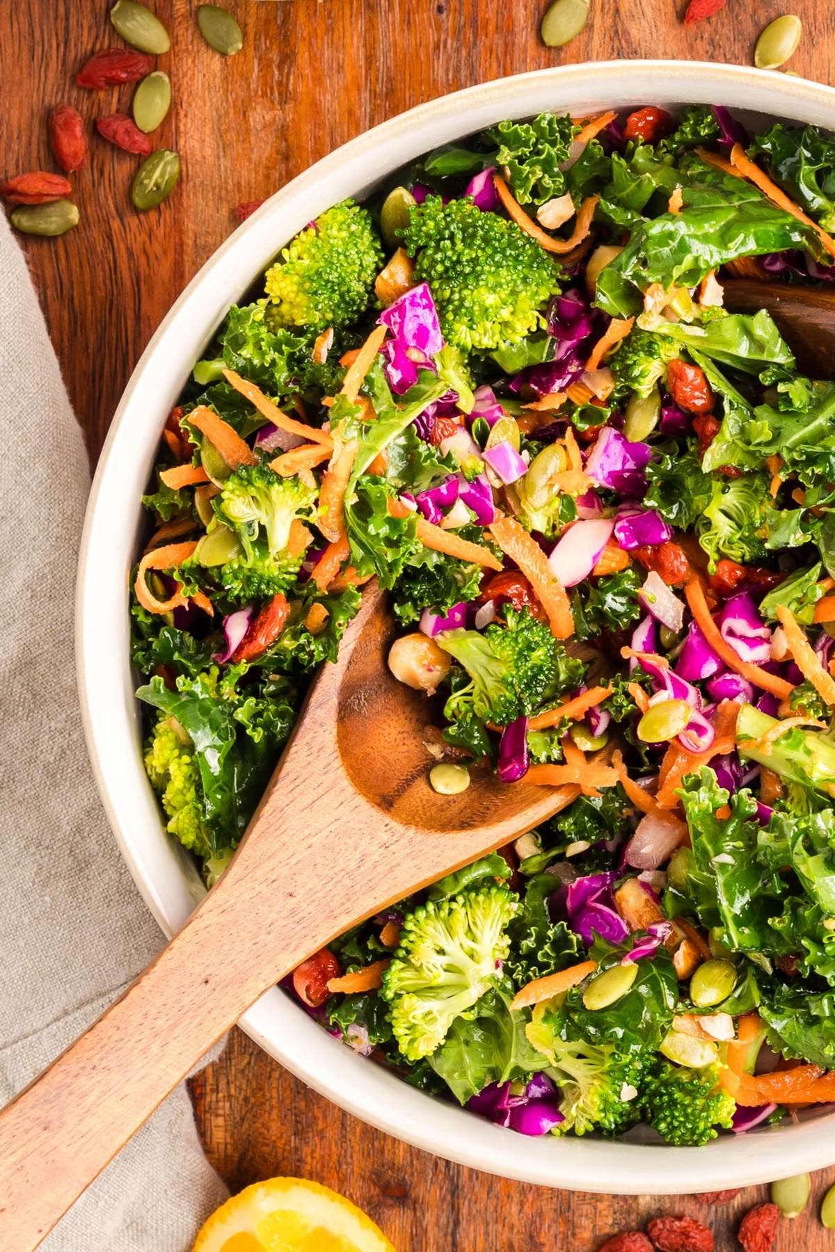 overhead of chopped kale salad with a wooden spoon