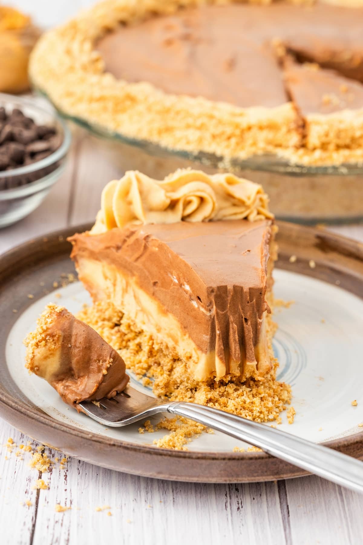 peanut butter chocolate cream pie with a fork on a plate