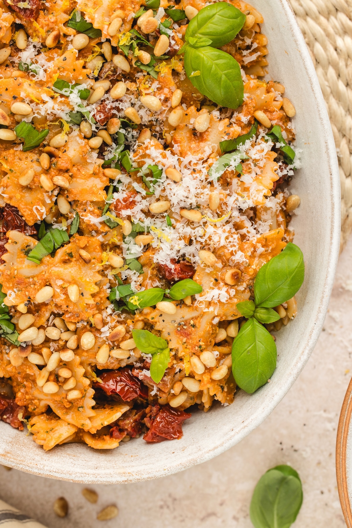 Sun-Dried Tomato Pesto Pasta in a bowl with fresh basil a bowlful of Sun-Dried Tomato Pesto Pasta