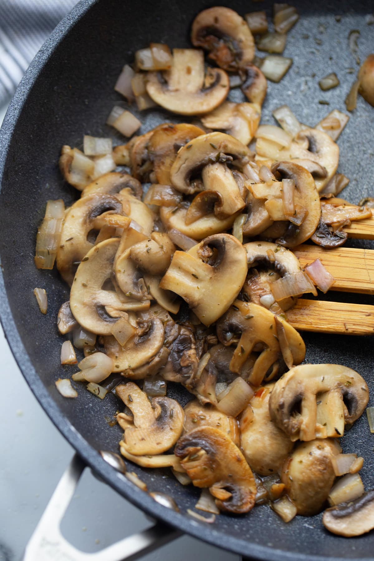 Browned mushrooms, shallots, and thyme cooking for the pork Marsala sauce.