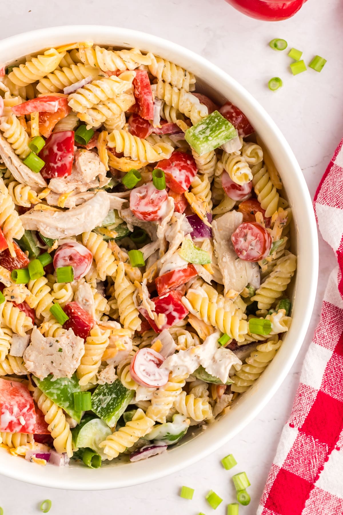close-up of Chicken Ranch Pasta Salad Overhead view of finished chicken ranch pasta salad in a serving bowl.
