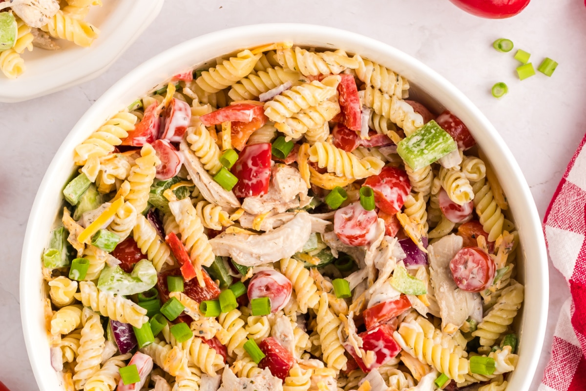 top view of Chicken Ranch Pasta Salad Close-up top view of creamy chicken ranch pasta salad with rotini, veggies, and cheese.