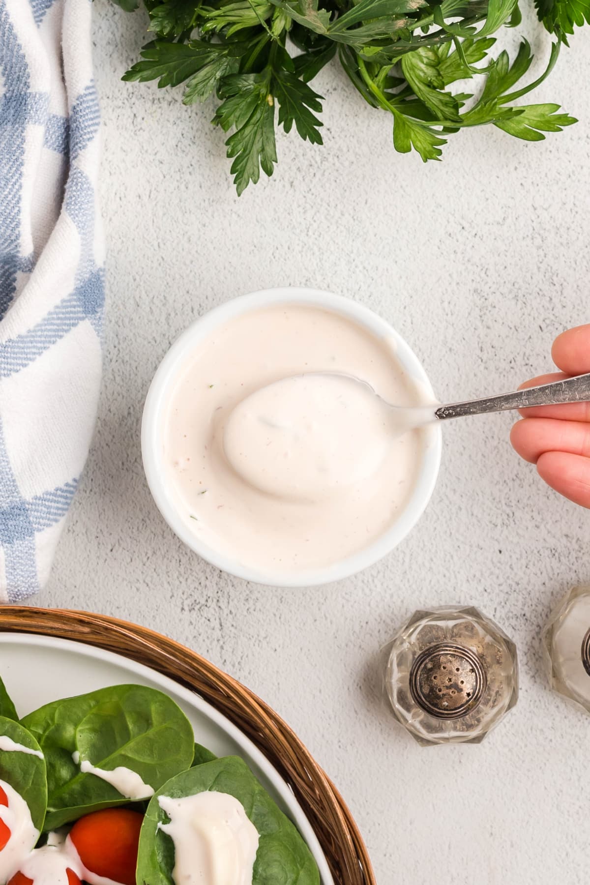 top view of Creamy Mayonnaise Salad Dressing Overhead view of creamy salad dressing in a ramekin with a spoon lifting some out