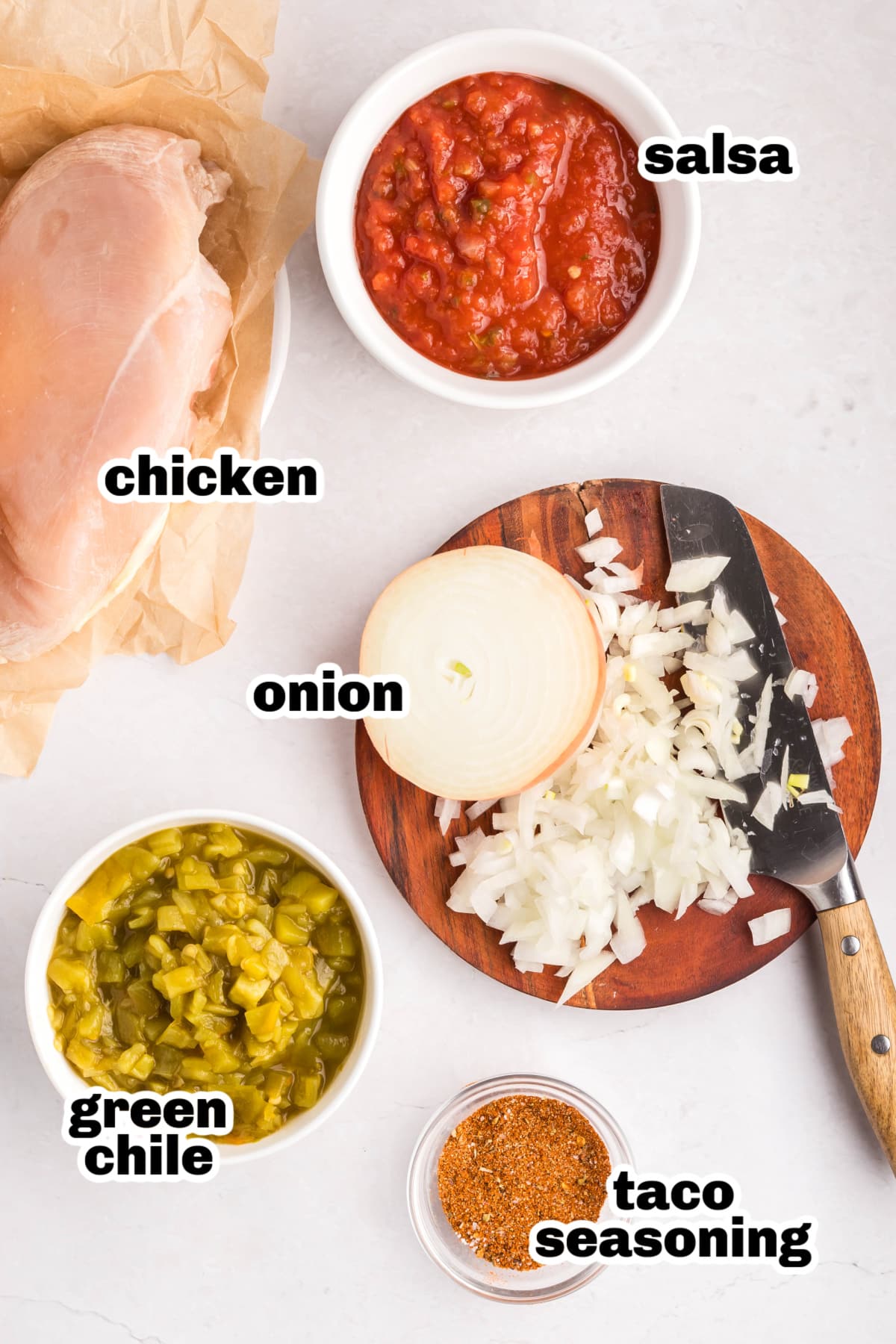 Overhead view of the five main ingredients laid out for slow cooker shredded taco chicken.