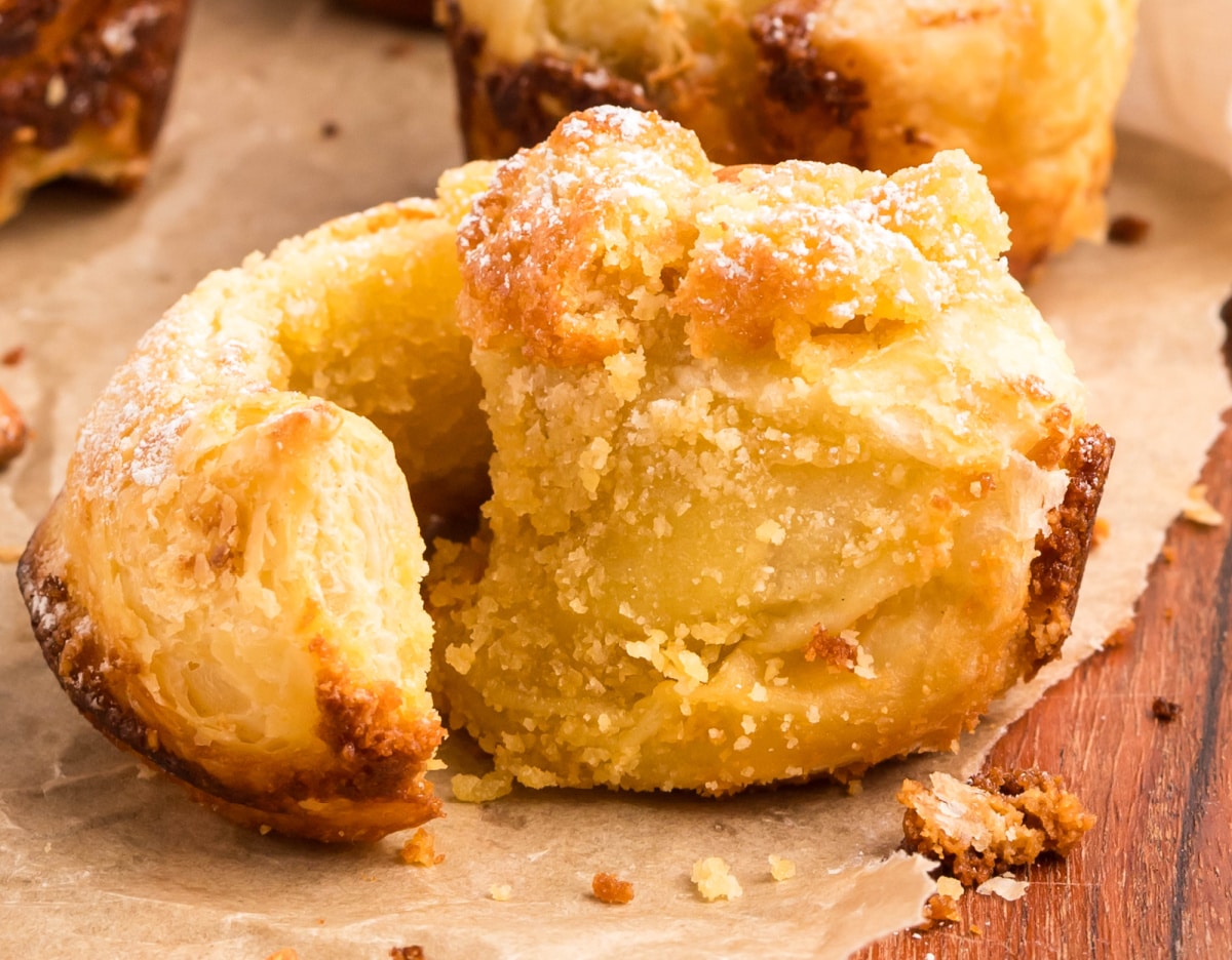one almond cruffin Side angle of a single cruffin with visible layers and a dramatic swirl pattern fanned out slightly.