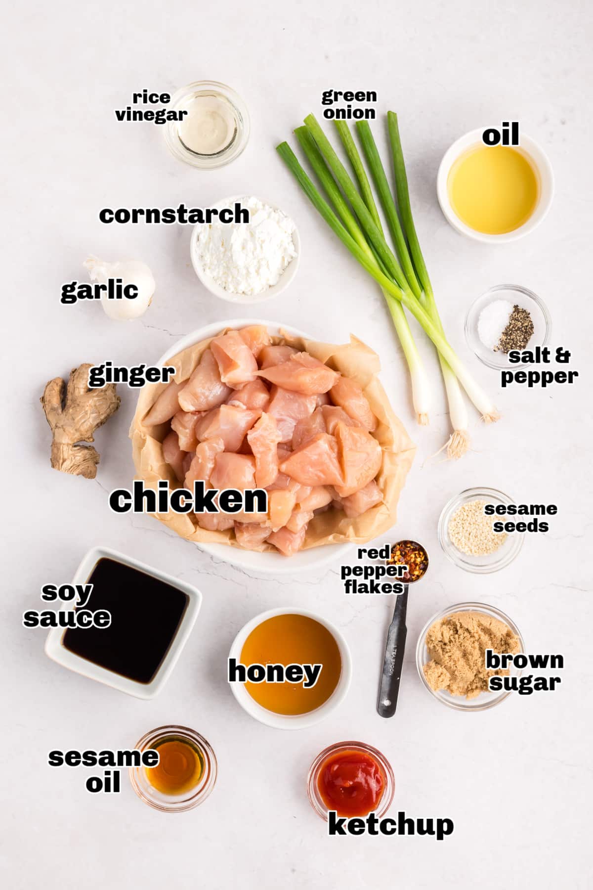 Honey Sesame Chicken ingredients Overhead view of all the measured ingredients arranged on a counter, ready to make honey sesame chicken.