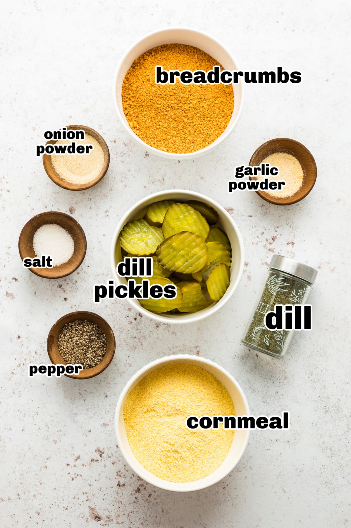 All ingredients needed for oven fried dill pickles arranged on a counter.