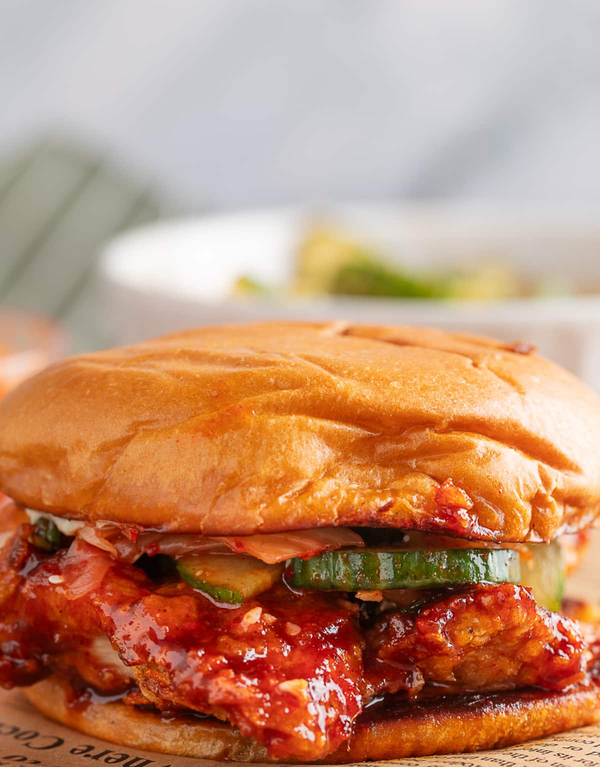 Detailed view of potato chip crust and sauce on chicken sandwich Close-up showing texture of crispy potato chip crust and sticky Gochujang glaze
