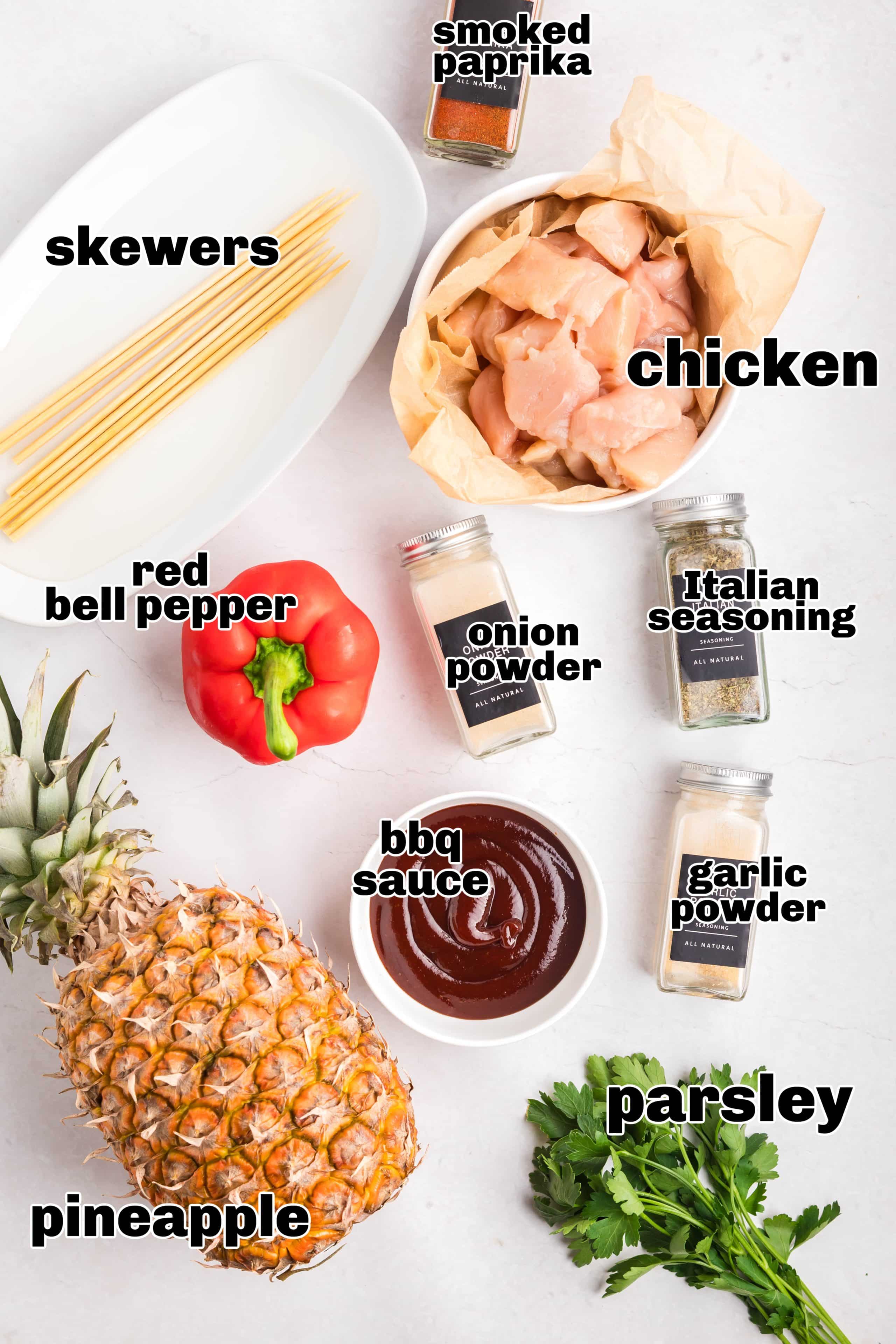 Ingredients for BBQ chicken skewers including chicken, spices, pineapple, and bell pepper