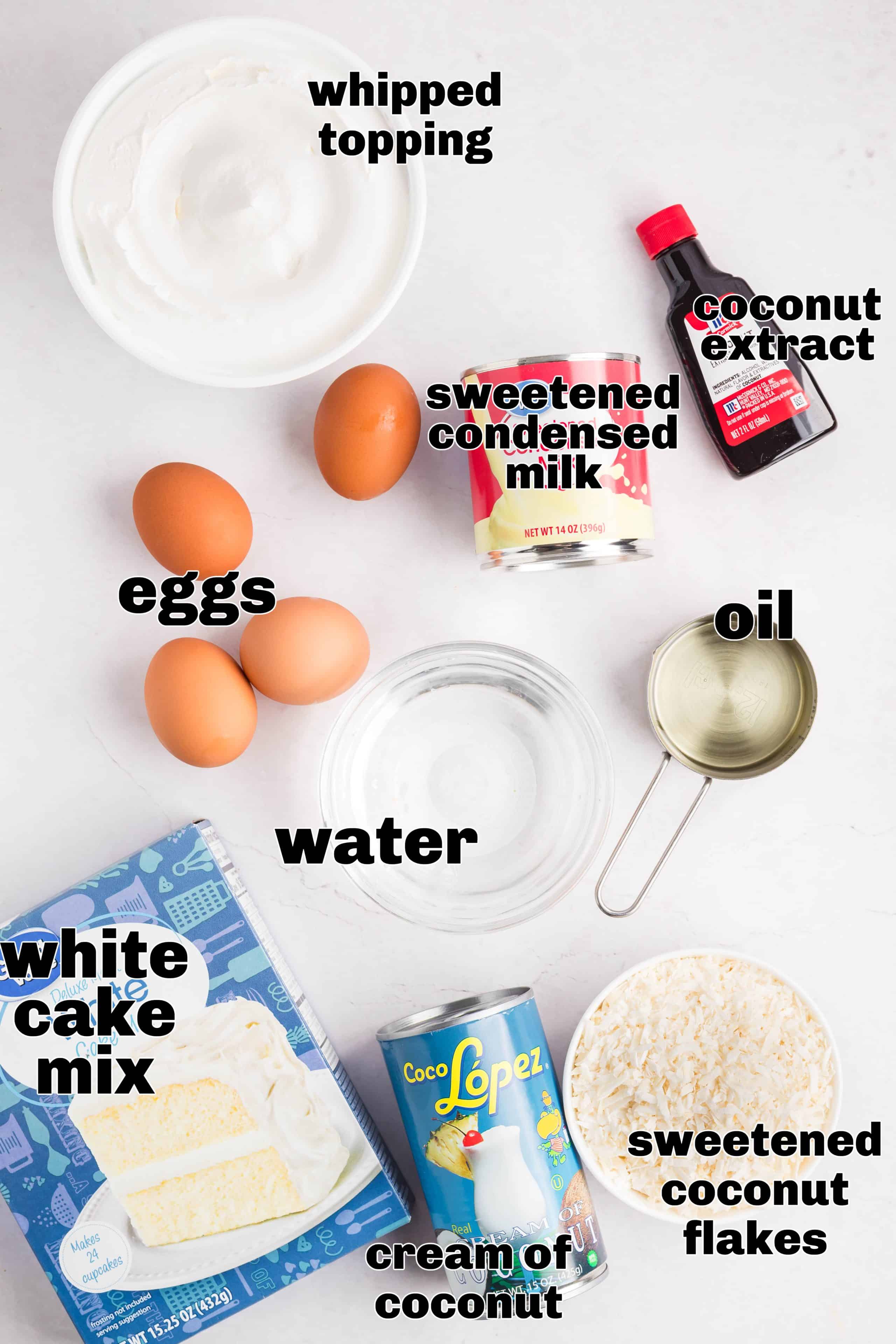 Ingredients for coconut poke cake measured and arranged on a white surface.
